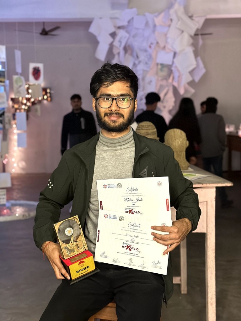 Nabin Joshi holding the X-Hack 3.0 trophy and certificates